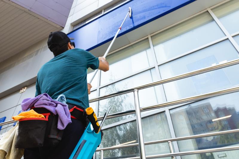 Person cleaning building facade