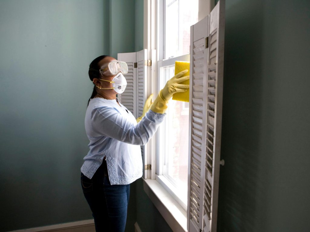 Person cleaning window indoors