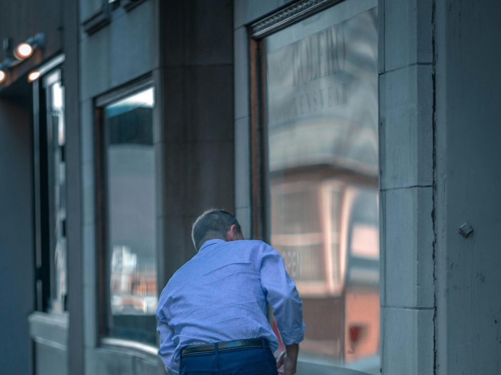 Man looking into a window